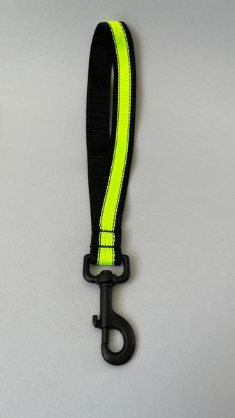 A Happy Hounds quick grab handle  made from yellow high quality, high visibility webbing photographed on a grey backround.